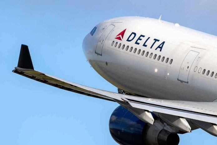 shutterstock_1474630895-1 Delta Air Lines commercial jet ascending with wing and engine visible