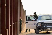 Injunction Freezes Big Bend Build – DOJ Fires Back Border patrol agents near a tall fence and a marked pickup truck