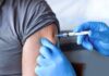 Pre‑Shot Painkillers Backfire? CDC Waves Red Flag Healthcare worker giving an arm injection