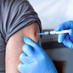 Pre‑Shot Painkillers Backfire? CDC Waves Red Flag Healthcare worker giving an arm injection