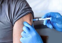 Pre‑Shot Painkillers Backfire? CDC Waves Red Flag Healthcare worker giving an arm injection