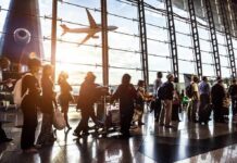 Air War Warning: Saudi Skies Declared Deadly Passengers queue inside an airport terminal at sunset