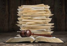 Transparency Fight Targets Oval Gatekeepers Stack of file folders with a judge's gavel on an open book