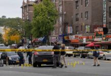 Nine Officers Targeted – One Falls Police investigate a taped-off urban street crime scene