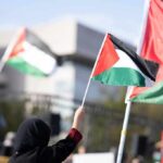 Terror Bloc Eyes Parliament Power Person waving a Palestinian flag at a rally
