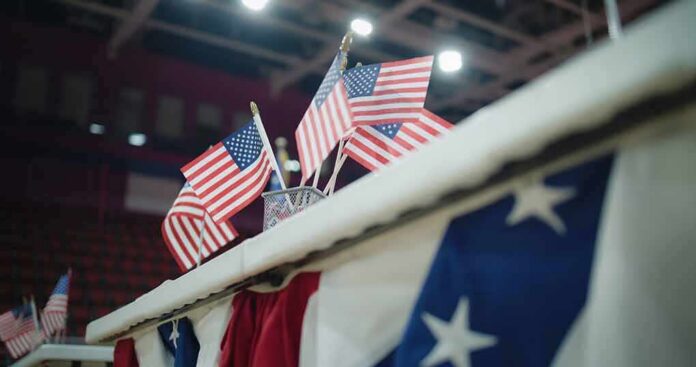 shutterstock_2454758073 American flags on display at an indoor venue