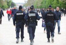 Weekend Mayhem – Paris Imposes Harsh Bans Police officers walking in a park among pedestrians