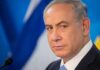 Governor Shifts Blame: Netanyahu Ouster Would ‘Help’ New York? man in suit at podium