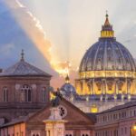 St. Peter's Basilica dome at sunset with glowing sky