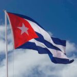 Cuban flag waving against a blue sky