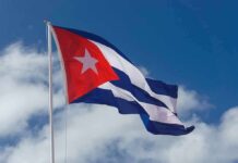 Cuban flag waving against a blue sky