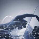 Jailbroken Bot – Chinese AI Breakout Rattles UK Lab Hand touching a tablet screen with abstract network overlay