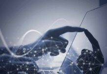 Hand touching a tablet screen with abstract network overlay