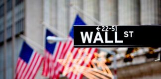 Wall Street sign with American flags in the background